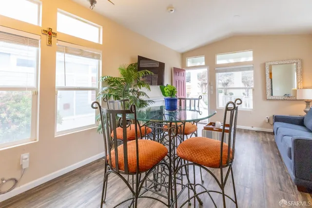 a dining room with furniture and a refrigerator