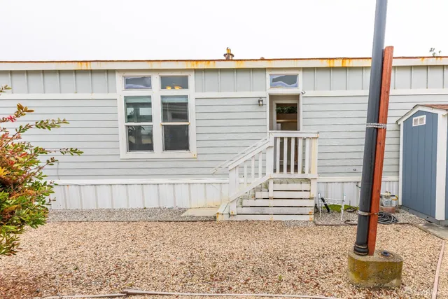 a view of a house with wooden fence