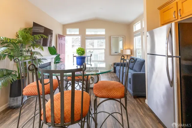 a living room with furniture a fireplace and a potted plant