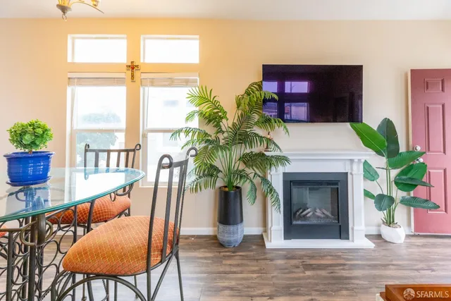 a living room with furniture wooden floor and a fireplace