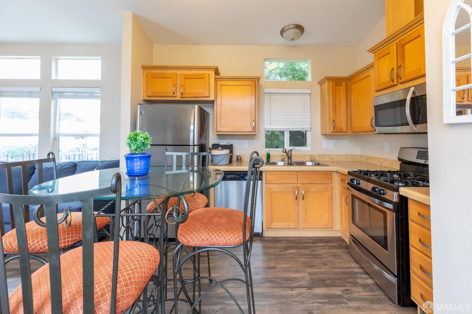 125 1st Avenue Pacifica, CA 94044 - Photo 10 of 55 a kitchen with stainless steel appliances granite countertop a stove a sink dishwasher a microwave oven and a dining table with wooden floor