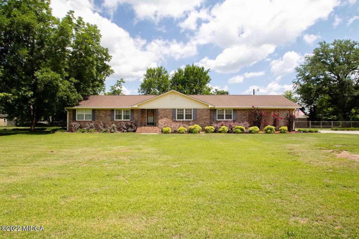 3663 Jones Road Macon, GA 31216 - Photo 1 of 30 a front view of a house with swimming pool having outdoor seating