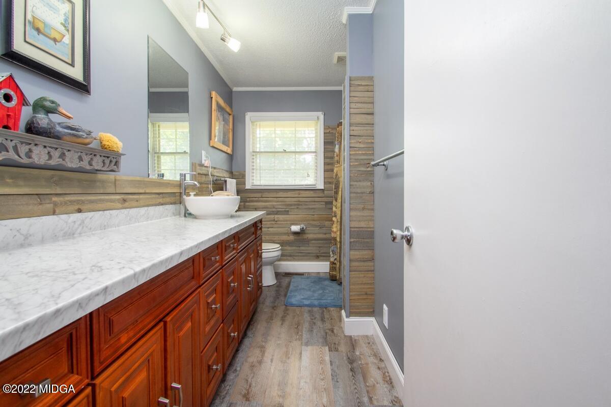 3663 Jones Road Macon, GA 31216 - Photo 17 of 30 a bathroom with a sink a mirror and a shower