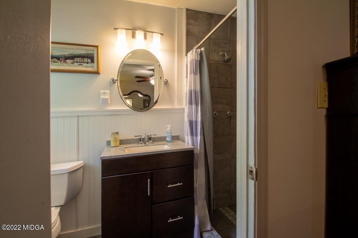 3663 Jones Road Macon, GA 31216 - Photo 21 of 30 a bathroom with a toilet sink vanity and mirror