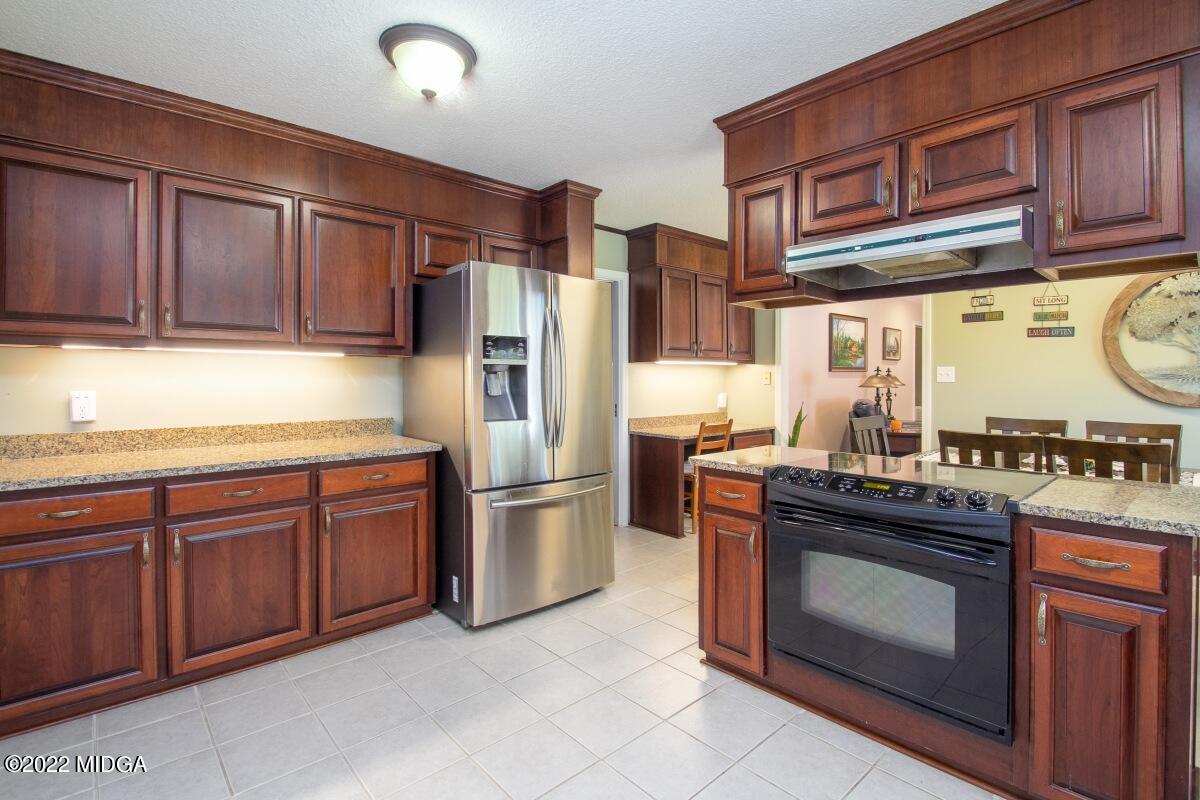 3663 Jones Road Macon, GA 31216 - Photo 10 of 30 a kitchen with stainless steel appliances granite countertop a stove refrigerator sink and cabinets