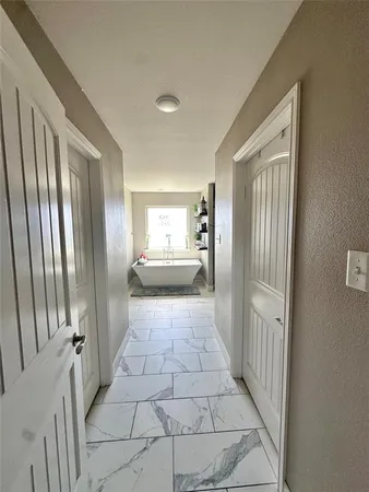 a bathroom with a glass door shower and a sink