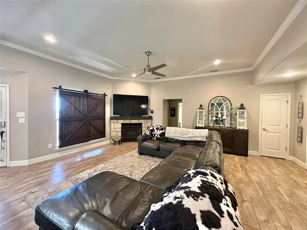 a bedroom with furniture a flat screen tv and a dresser