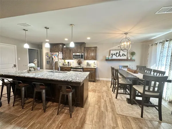 a kitchen with a table and chairs in it