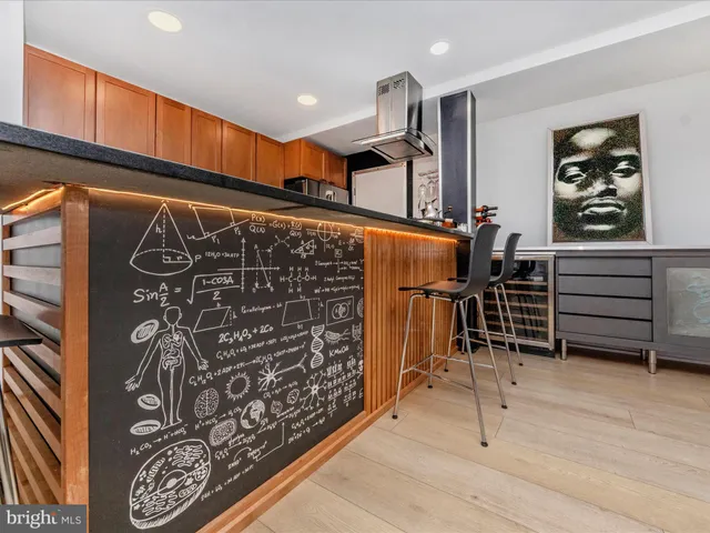 a kitchen with stainless steel appliances kitchen island granite countertop a refrigerator and wooden cabinets