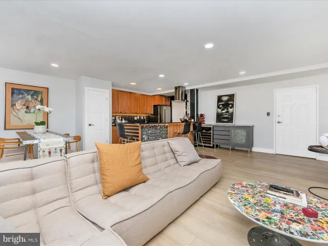 a living room with furniture and kitchen view
