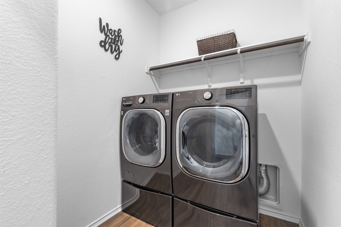 432 Clear Springs Road Georgetown, TX 78628 - Photo 11 of 27 Washroom with a textured wall, separate washer and dryer, and wood finished floors