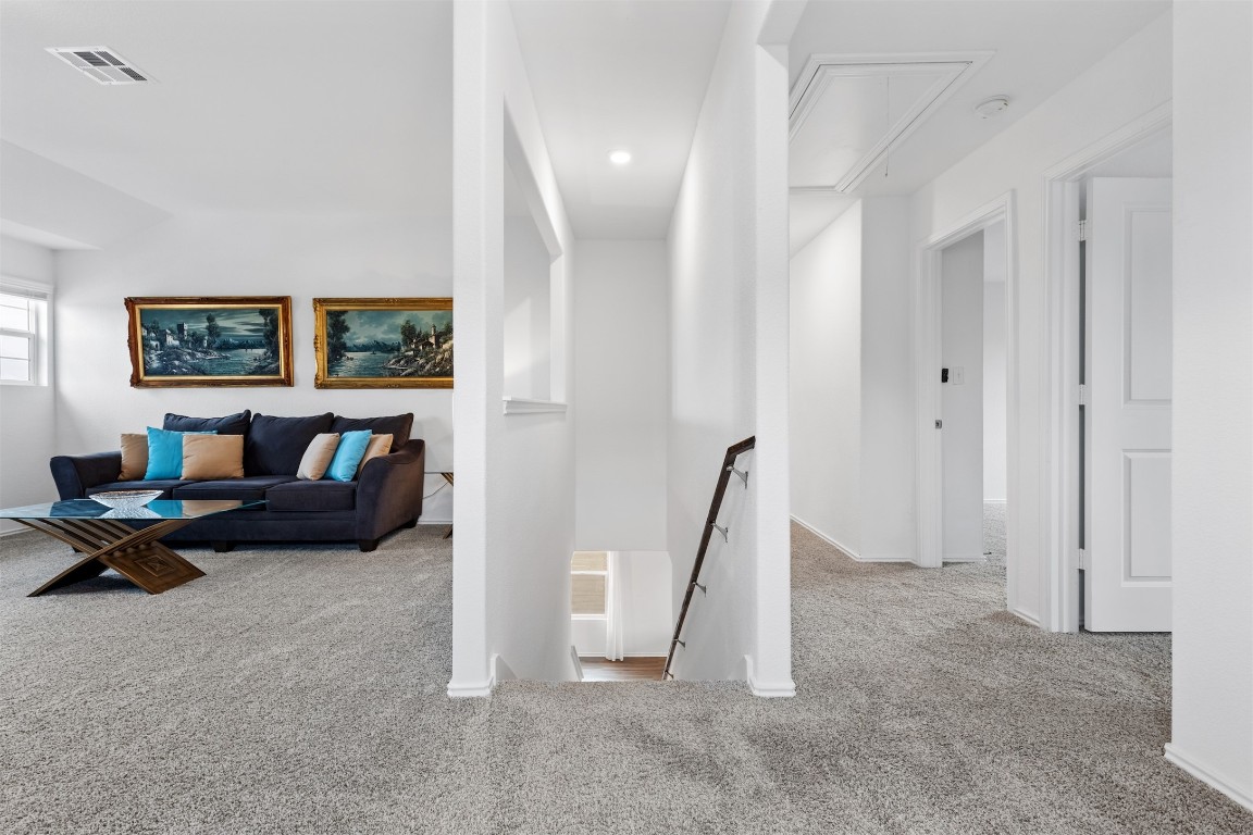 432 Clear Springs Road Georgetown, TX 78628 - Photo 12 of 27 Corridor with an upstairs landing, attic access, and carpet