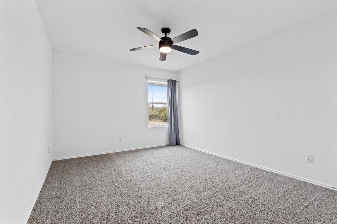 432 Clear Springs Road Georgetown, TX 78628 - Photo 19 of 27 Carpeted spare room with a ceiling fan and baseboards