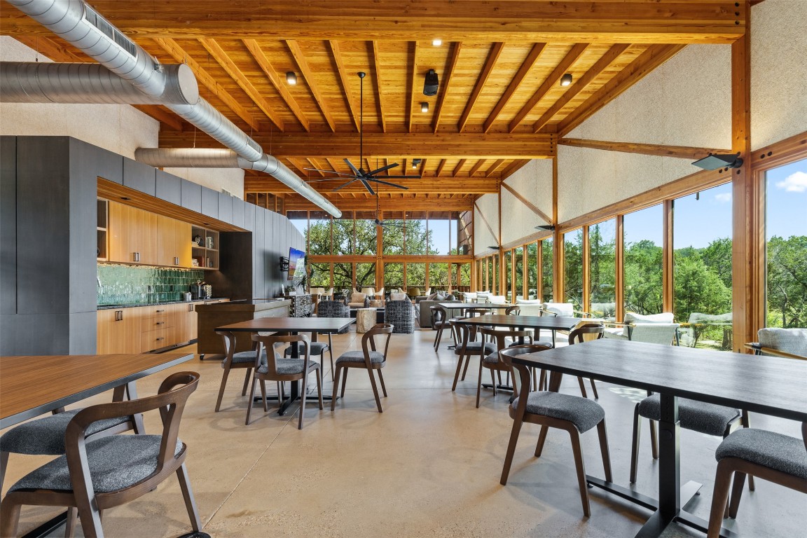 432 Clear Springs Road Georgetown, TX 78628 - Photo 25 of 27 Dining area with finished concrete flooring, a wood ceiling with exposed beams, and a towering ceiling