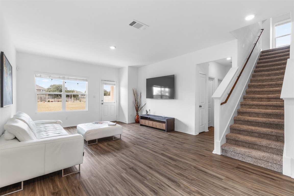 432 Clear Springs Road Georgetown, TX 78628 - Photo 4 of 27 Living area with plenty of natural light, dark wood-type flooring, stairway, and recessed lighting