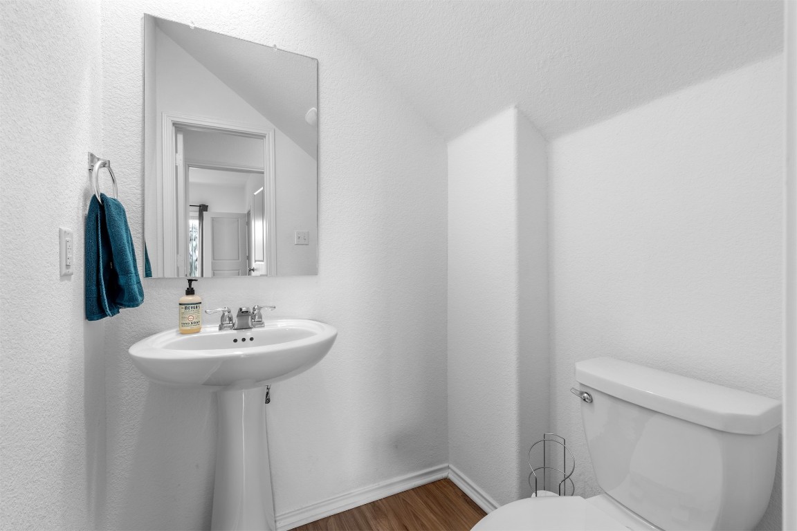 432 Clear Springs Road Georgetown, TX 78628 - Photo 10 of 27 Bathroom with dark wood-style flooring and a textured wall