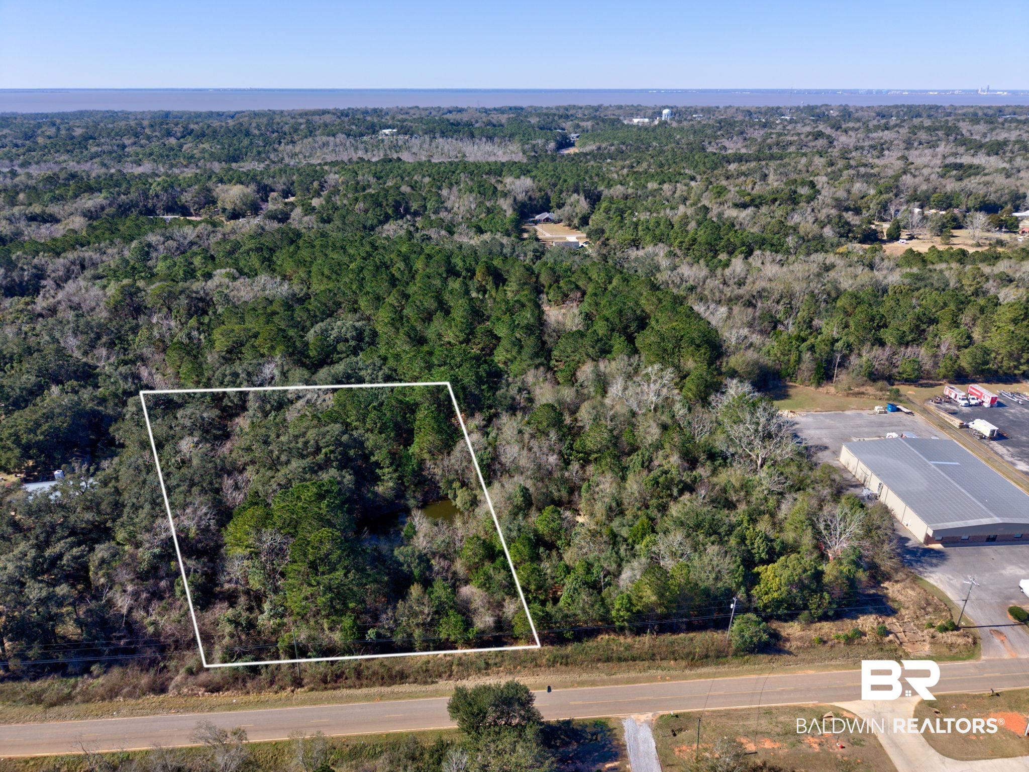 25280 Friendship Road Daphne, AL 36526 - Photo 13 of 34 Aerial view of property's location with property boundaries highlighted and a heavily wooded area