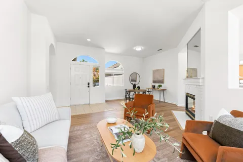 a living room with furniture fireplace and a table