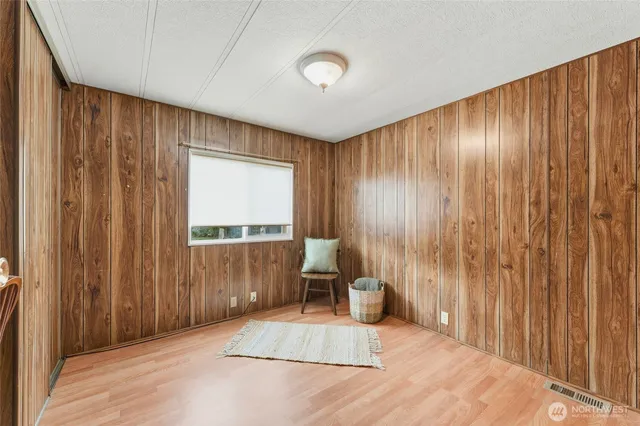 a spacious bedroom with a large bed and a large window