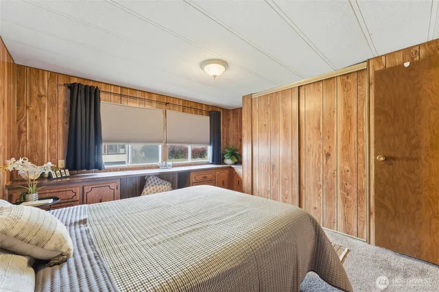 a bedroom with a large bed and a large window