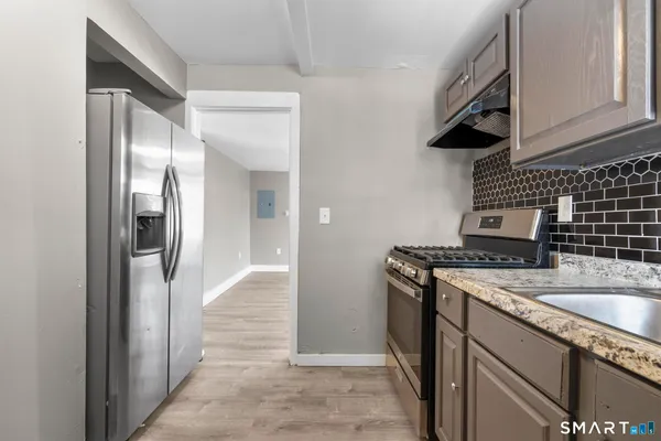 a kitchen with a refrigerator and a sink