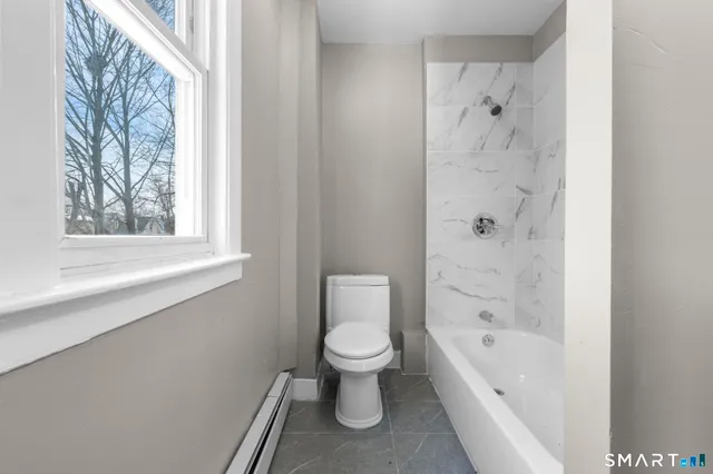 a bathroom with a toilet and a bathtub