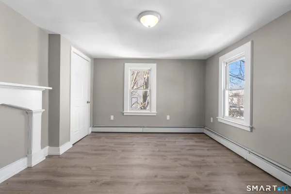an empty room with windows and closet