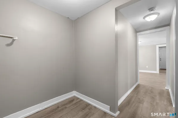 a view of a room with wooden floor