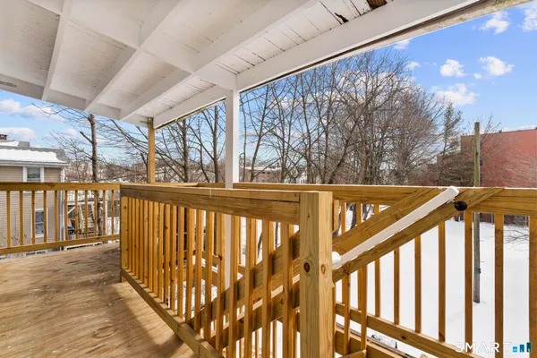 a view of a balcony with wooden floor