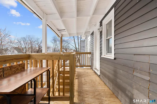 a view of a house with a wooden fence