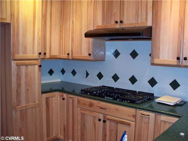 65 Olde Footpath Road Aylett, VA 23009 - Photo 4 of 12 Kitchen - Pictures don't do this Kitchen justice! You must see it with your own eyes! Custom Cabinets, Hardwood Floors, Kitchenaid Convection Oven, Garbage Compactor, Dishwasher and Gas Stove! Also no-slam drawers round out this fantastic Kitchen!