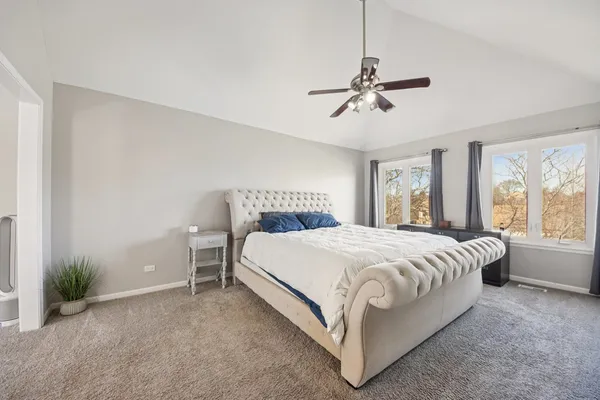 a view of a backyard with table and chairs and a barbeque