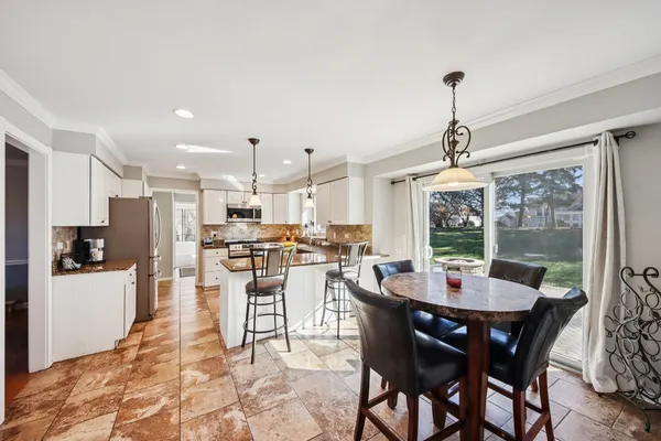 a kitchen with stainless steel appliances granite countertop a stove top oven a sink and dishwasher a refrigerator with wooden floor