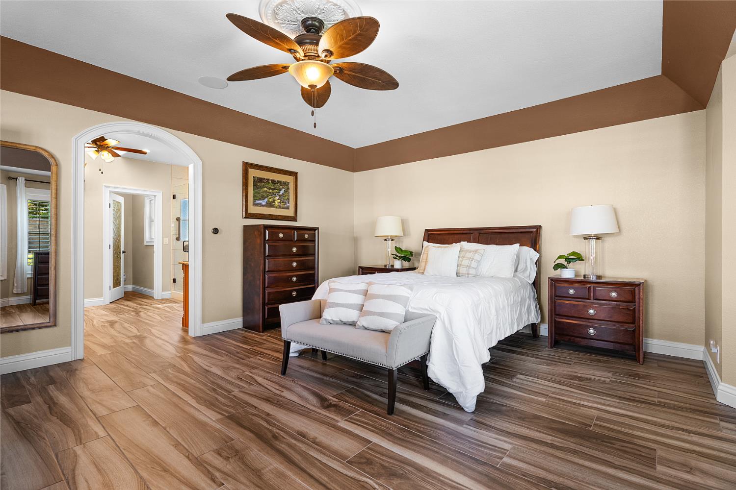 8300 Auburn Folsom Road Granite Bay, CA 95746 - Photo 16 of 45 a spacious bedroom with a bed and a chandelier