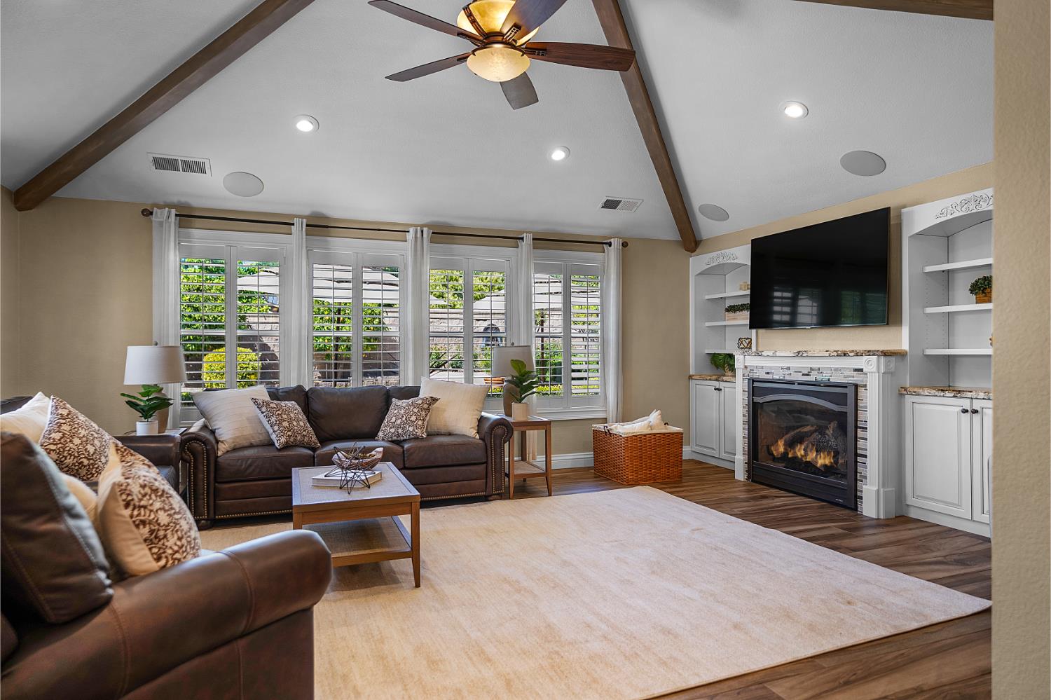 8300 Auburn Folsom Road Granite Bay, CA 95746 - Photo 9 of 45 a living room with furniture a fireplace and a flat screen tv