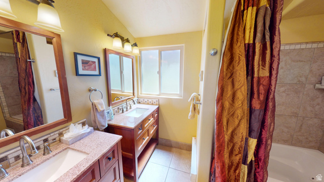 315 Abbey Road Moab, UT 84532 - Photo 22 of 46 Full bath with two vanities, shower / tub combo with curtain, and light tile patterned floors