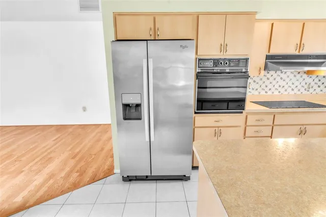 a bedroom with a bed couches and a flat tv screen