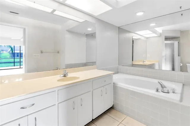 a view of a house with backyard and a trees