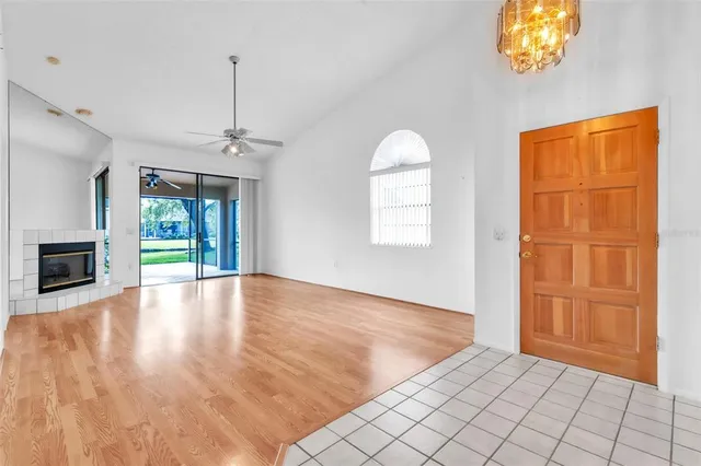 a view of a room with a window and wooden floor