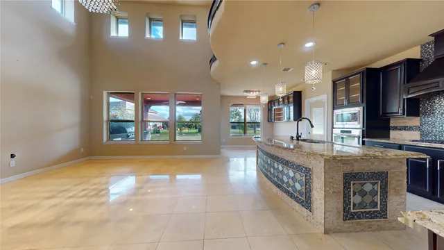 a large kitchen with stainless steel appliances granite countertop a sink and a stove