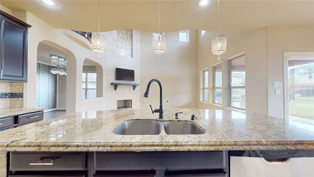 a view of a living room with a fireplace and a floor to ceiling window