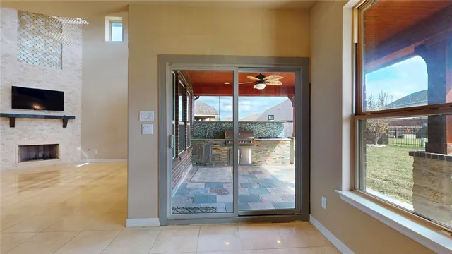 a view of kitchen with stainless steel appliances wooden floor and window