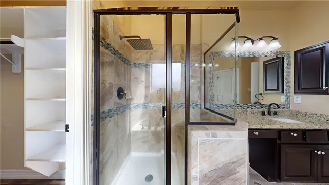 a view of walk in closet with wooden floor