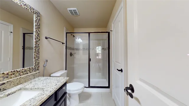 a bathroom with a glass shower door