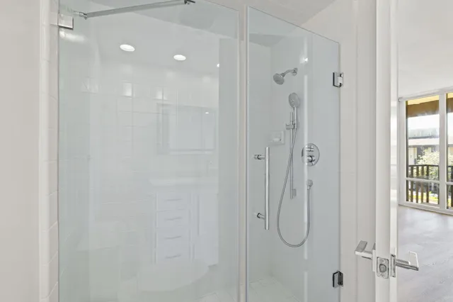 a bathroom with a glass shower door