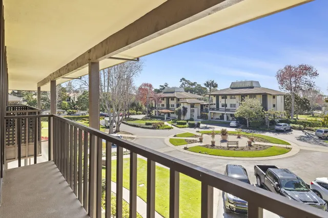a view of a swimming pool with a patio and wooden floor