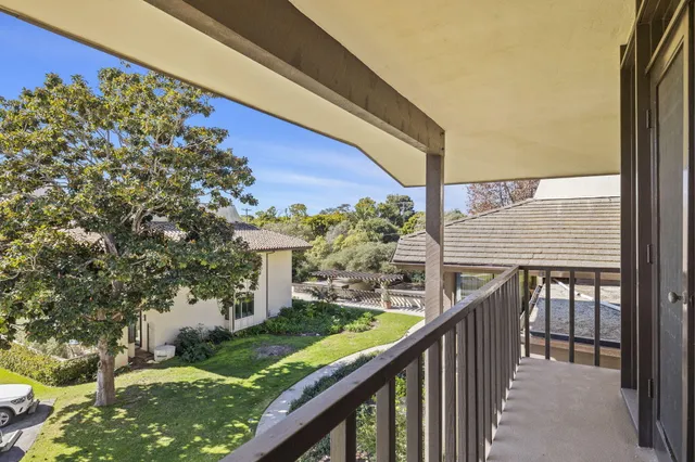 a balcony with wooden floor and outdoor seating