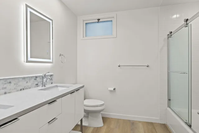 a bathroom with a toilet a sink and shower