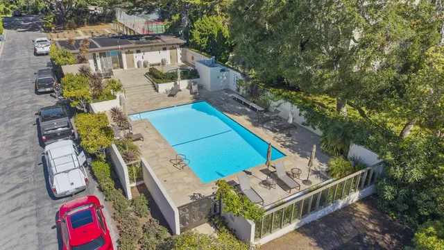 an aerial view of a house with balcony and outdoor space
