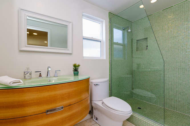 1330 Beachmont Street Ventura, CA 93001 - Photo 14 of 35 a bathroom with a granite countertop sink toilet and mirror